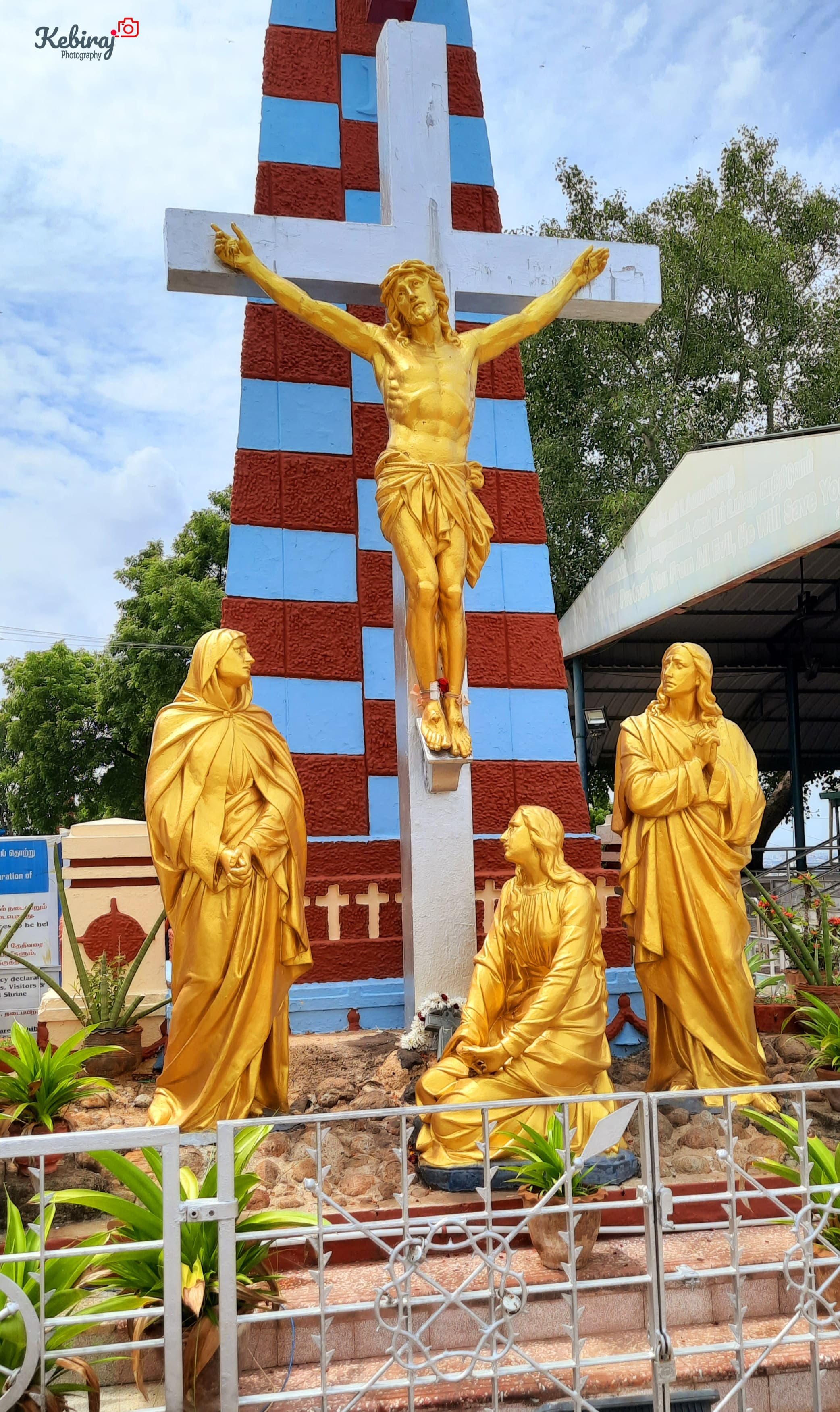 The striking golden sculptures, towering cross, and vibrant colors immediately drew my attention.